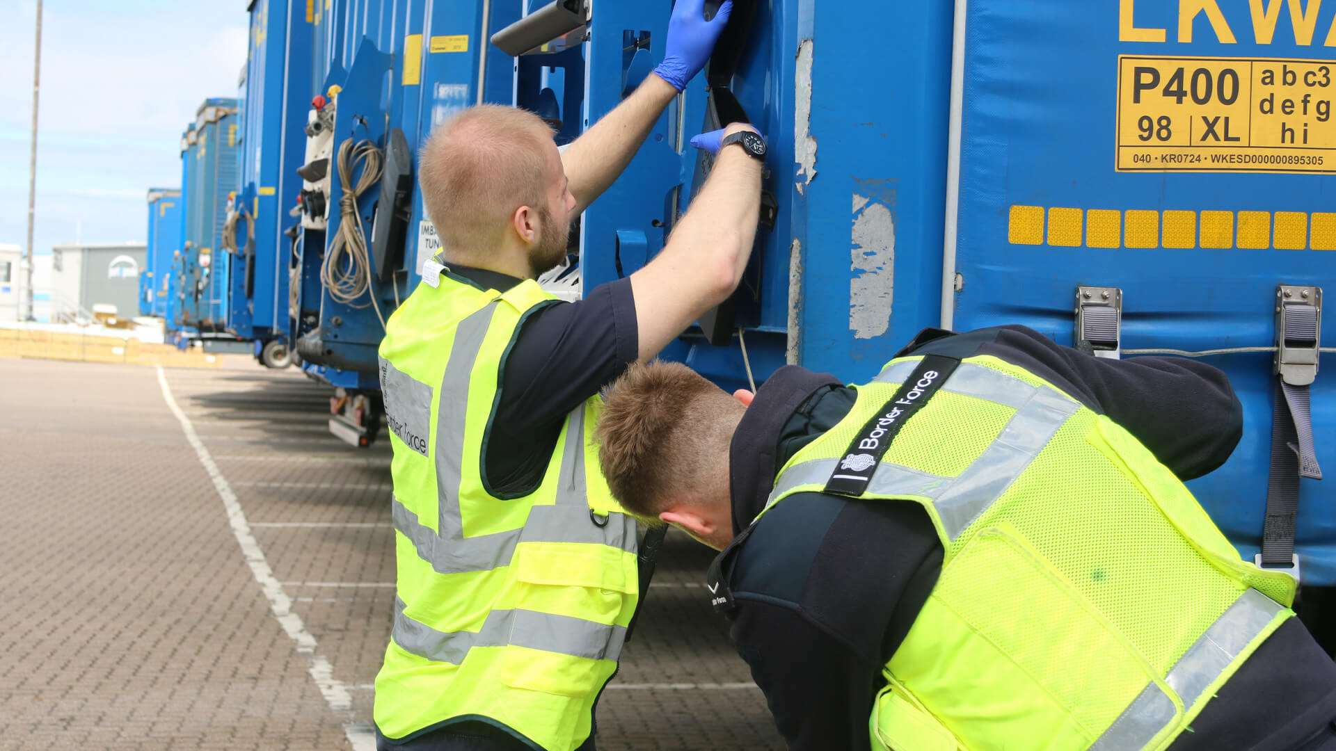 Two Border Force officers examine a truck